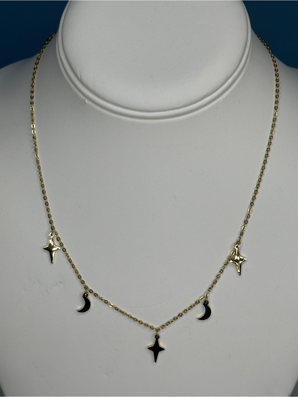 Gold tone stainless steel star and moon necklace